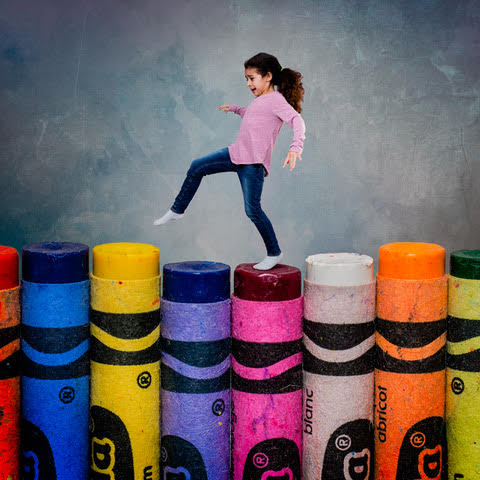 girl skipping on crayons